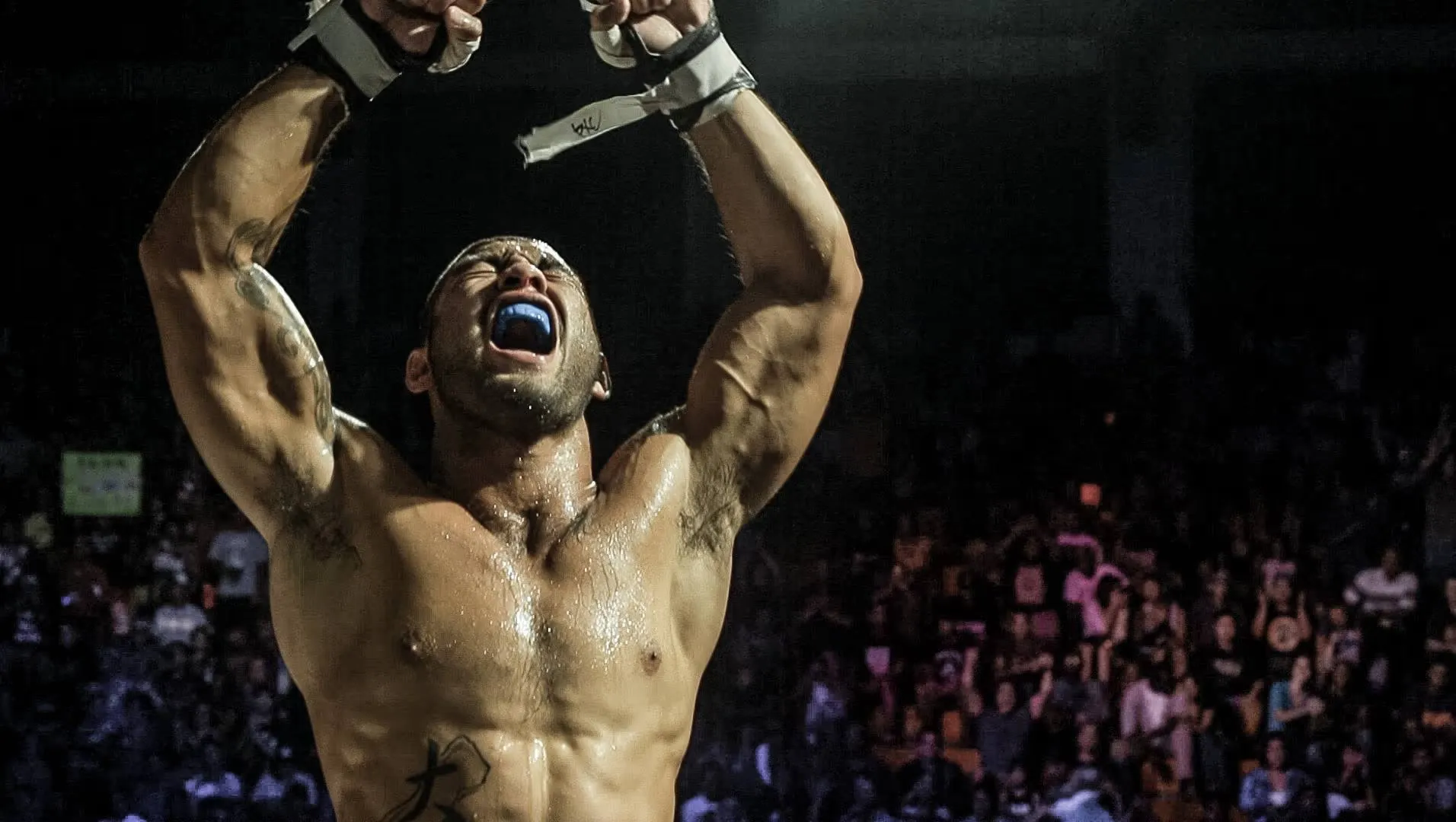 Frank Camacho roaring in celebration after a victory inside the cage